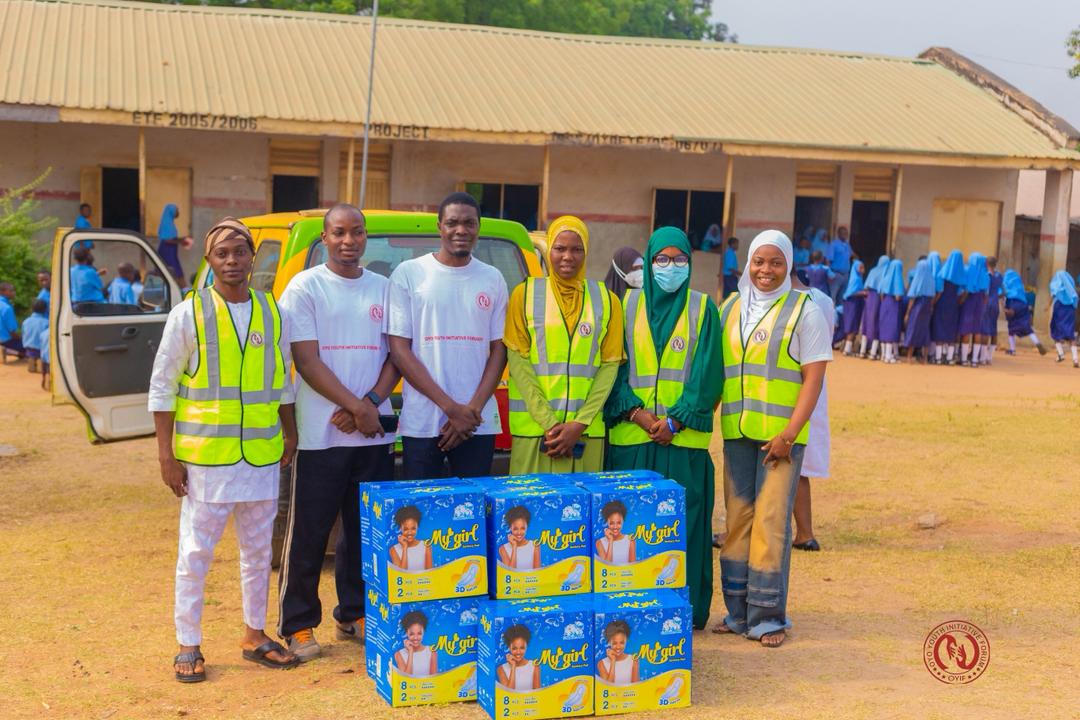 OYIF volunteers with boxes of sanitary pads for donation at a school